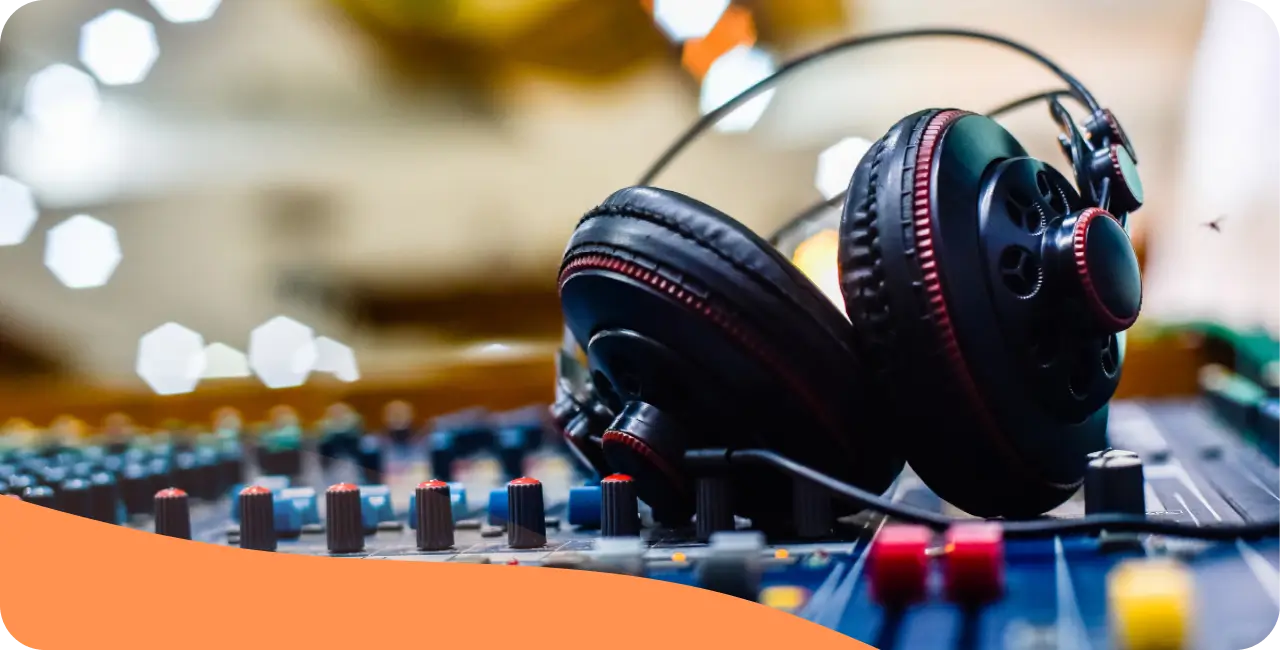A pair of headphones resting on a mixing desk